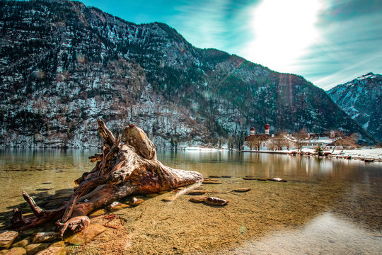 The beautiful koenigssee (kings lake) in germany with the St. Bartholome (famous pilgrimage church), the mountains and a wonderful sky