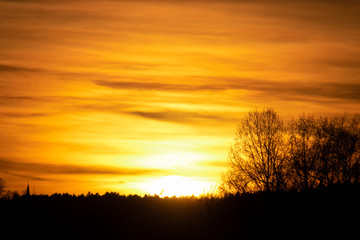 Fototapeta na wymiar a beautiful orange sunset with a few clouds and sun rays