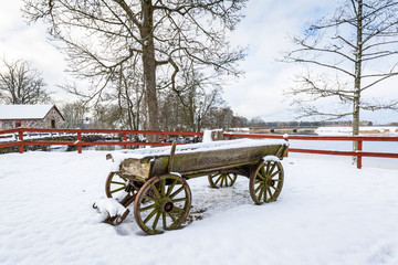 Winter scenery with old horse cart in Sweden