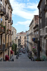 Fototapeta na wymiar Street with stairs in Catania, Sicily, Italy