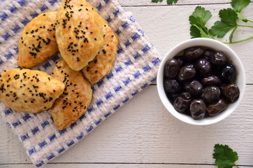 donut with olives on wooden table