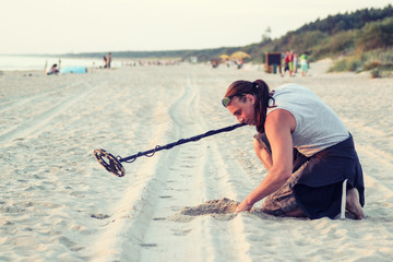 Man with metal detector on the beach