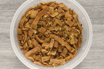 Homemade rye croutons with garlic for a snack to beer lie on the table.