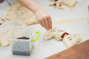 Obraz na płótnie Canvas Young children make dough products. Hands closeup