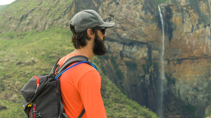 Tourist walking along trails and photographing the Tabuleiro Waterfall 