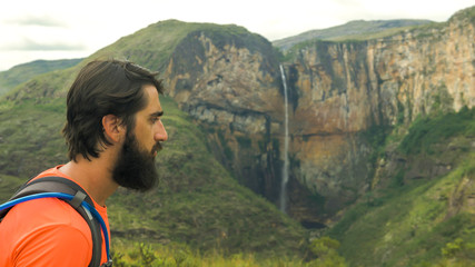 Naklejka premium Tourist walking along trails and photographing the Tabuleiro Waterfall 