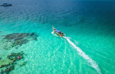 Longtail boats from the air, paradise island , crystal clear water, amazing scenery, on fyre. 