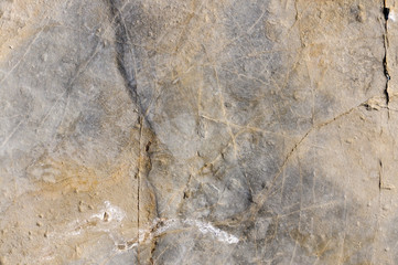 Texture of dark gray slate or background for design..The surface of the rock is a surface with a wave pattern.