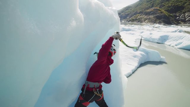 Ice climber using hooks ascending glacier / Palmer, Alaska, United States