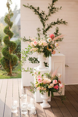 Coziness and style. Modern event design. Lounge zone and european traditional wedding ceremony decoration outdoors in the restaurant before the reception.