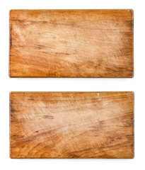 Two used scratched wooden cutting boards, on white background.