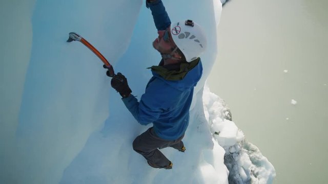 High angle view of ice climber using hooks ascending glacier / Palmer, Alaska, United States