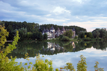 Fototapeta na wymiar Impressive lake house. Reflected on water.