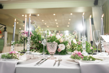 Floral decoration for wedding ceremony romance dining. Wedding banquet , festive decor. Bouquet from spring and summer flowers. Table layout. Restaurant interior. Concept of service and catering.