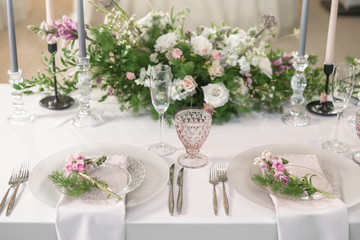 Floral decoration for wedding ceremony romance dining. Wedding banquet , festive decor. Bouquet from spring and summer flowers. Table layout. Restaurant interior. Concept of service and catering.
