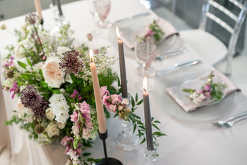 Floral decoration for wedding ceremony romance dining. Wedding banquet , festive decor. Bouquet from spring and summer flowers. Table layout. Restaurant interior. Concept of service and catering.