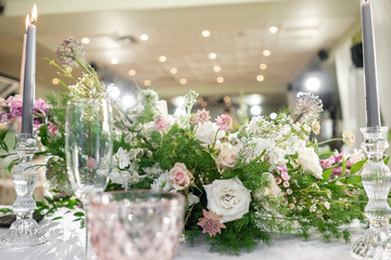 Floral decoration for wedding ceremony romance dining. Wedding banquet , festive decor. Bouquet from spring and summer flowers. Table layout. Restaurant interior. Concept of service and catering.