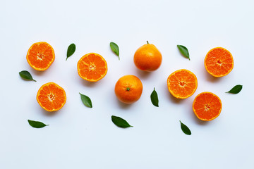 Orange fruits and green leaves on a white background.