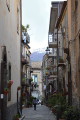 Narrow street in old town with etna in the background, Randazzo, Sicily, Italy