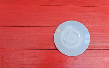 Empty white coffe cup on red wooden table. Copy space