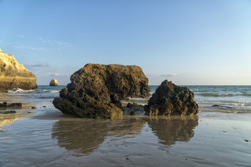 Rock formations on a Praia da Rocha in Portimao, Algarve region, Portugal. Late afternoon of sunny summer day.