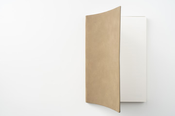opened brown notebook on white background
