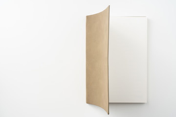 opened brown notebook on white background