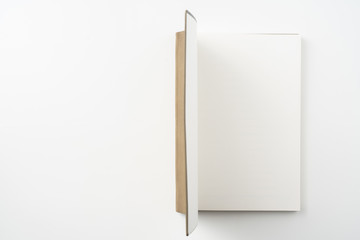 opened brown notebook on white background