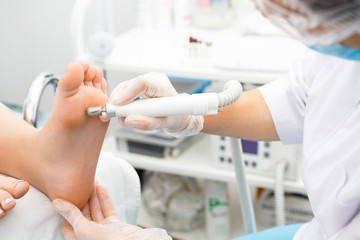 Professional pedicurist working at the salon