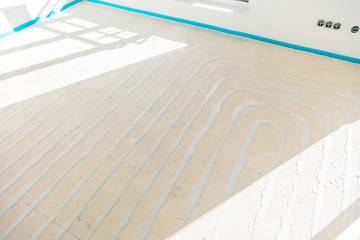 Water underfloor heating pipes in a concrete floor.