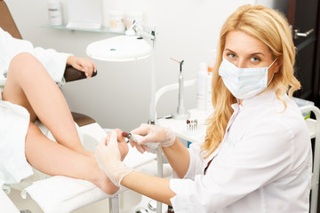Professional pedicurist working at the salon