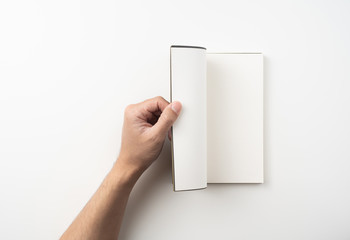 man hand hold brown notebook on white background