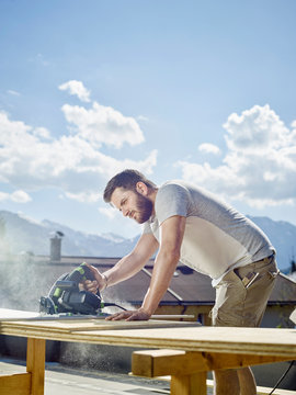Carpenter working, circular saw