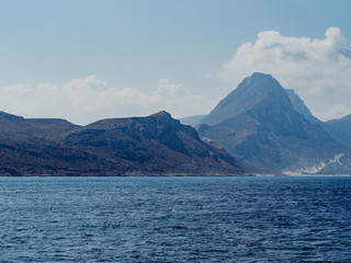 Fototapeta na wymiar Dark and moody mountains of Crete - view from the sea
