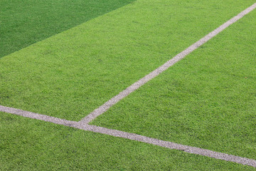 Obraz premium The white Line marking on the artificial green grass soccer field