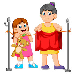 Little girl helping hang laundry her mother