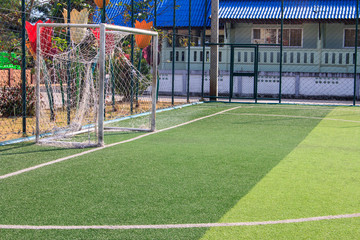 The white Line marking on the artificial green grass soccer field