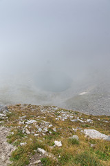 Panorama of Ledenoto (Ice) Lake and clouds over Musala Peak, Rila mountain, Bulgaria