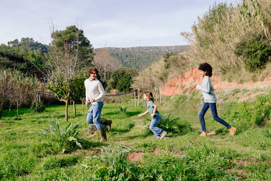 Happy family walking in the countryside, in a row