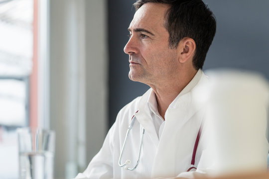 Portrait of thoughtful doctor in medical practice looking sideways