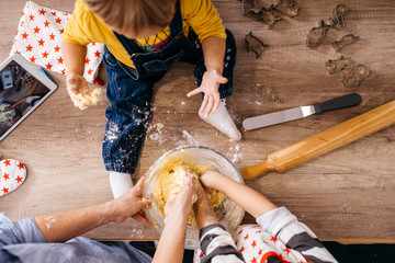 Mother and children preparing dough together