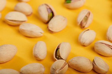 Group of pistachio on yellow background