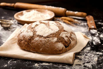 Bread and flour on a black table