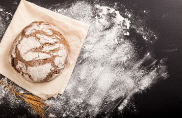 Bread and flour on a black table