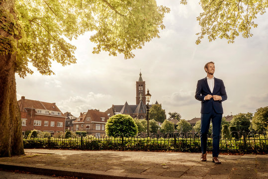 Netherlands, Venlo, businessman standing on pavement