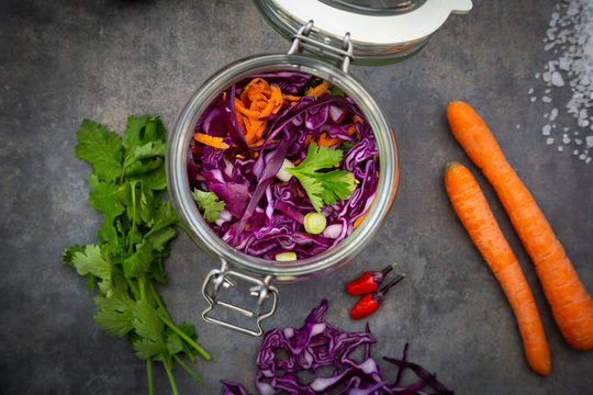Homemade red cabbage, fermented, with chili, carrot and coriander, in a preserving jar
