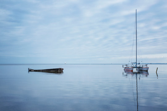 Germany, Ruegen, Putbus, Lauterbach, catamaran and boat wreck on the Baltic Sea