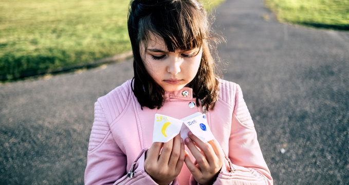 Portrait of little girl playing 'Heaven or Hell'