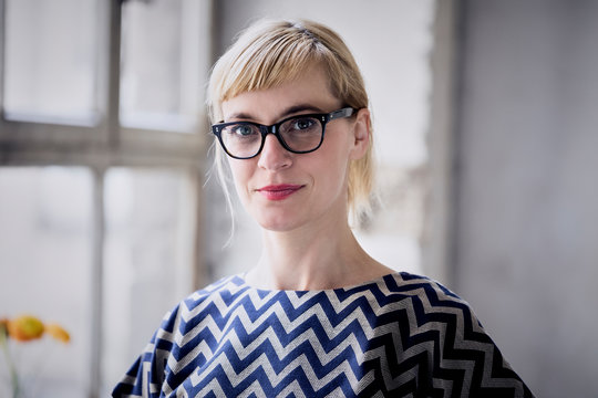 Portrait of blond businesswoman wearing glasses