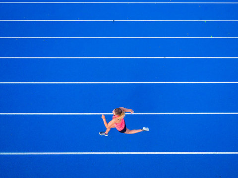Top view of female runner on tartan track